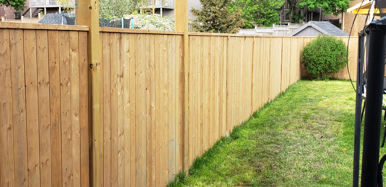 tall wooden privacy fence at backyard